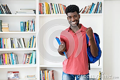 Cheering afro american male student with backpack and copy space Stock Photo