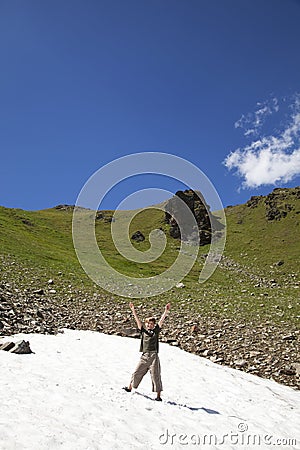 Cheering boy in a snowfield Stock Photo