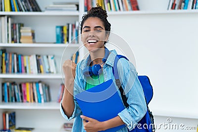 Cheering brazilian female student with backpack Stock Photo