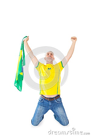 Cheering brazilian football fan in yellow Stock Photo