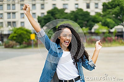 Cheering brazilian girl with curly hair braces Stock Photo