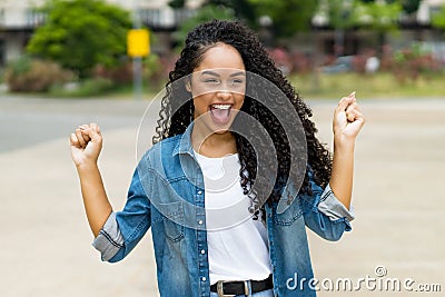 Cheering brazilian young adult woman with retainer Stock Photo