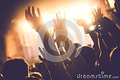 Cheering crowd with hands in air at music festival Stock Photo