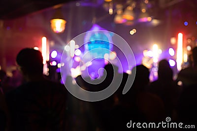 Cheering crowd at a party concert. Silhouettes of audience people at live concert stage show. Happy fan cheer musician band, nigh Stock Photo