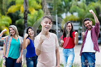 Cheering german young adult with group of male and female friends Stock Photo