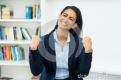 Cheering latin american mature businesswoman with blazer Stock Photo