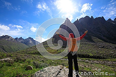 Hiker with backpack hiking on high altitude mountain Stock Photo