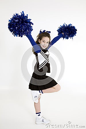 Nine year old Caucasian girl dressed in a blue cheerleader outfit Stock Photo
