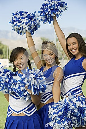 Cheerleaders Holding Pom-Poms Stock Photo