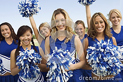 Cheerleaders Holding Pom-Poms Stock Photo