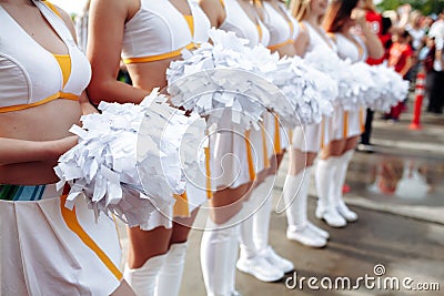 Cheerleaders in white Uniform Holding Pom-Poms. Close up . football championship Stock Photo