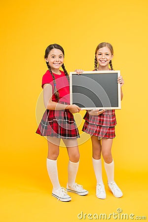 Cheerleading classes. School girls cute pupils red uniform hold blackboard copy space. School announcement concept Stock Photo