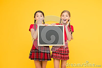 Cheerleading classes. School schedule. School girls cute pupils red uniform hold blackboard copy space. School Stock Photo
