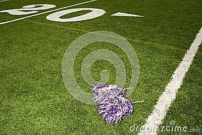 Cheerleading pom-poms on football field Stock Photo