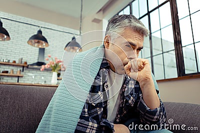 Cheerless unhappy man suffering from strong cough Stock Photo