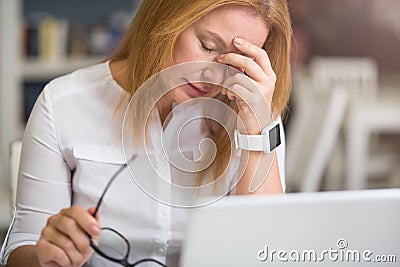 Cheerless woman sitting at the table Stock Photo