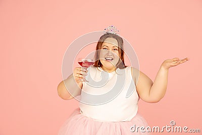 Beautiful caucasian plus size model isolated on pink studio background. Concept of inclusion, human emotions, facial Stock Photo