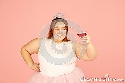 Beautiful caucasian plus size model isolated on pink studio background. Concept of inclusion, human emotions, facial Stock Photo