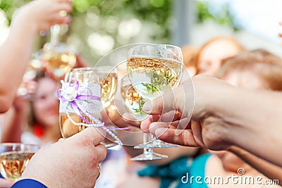 Cheers. Group of people drinking and toasting in restaurant. Hands holding glasses of champagne and wine making toast Stock Photo