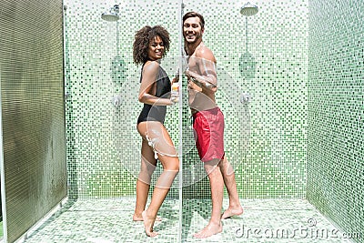 Cheery youthful couple having fun taking shower together Stock Photo