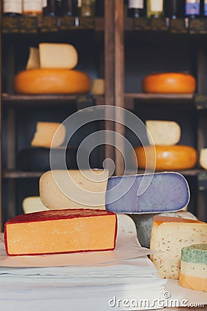 Cheese assortment. Coloured gouda and parmesan cheese at grocery Stock Photo