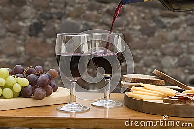 Cheese, grapes, bread, wine on a table Stock Photo