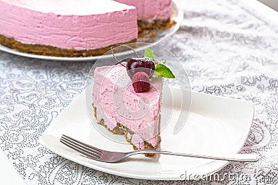 Cheese cake and slice on plate Stock Photo