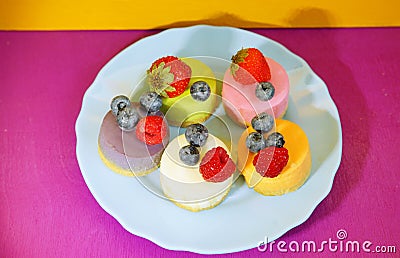 Cheese cakes with berries on colourful background. Restaurant menu. Food art. Colourful dish. Sweet meal. Stock Photo