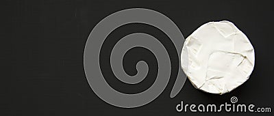 Cheese camembert or brie on black background, top view. Milk production. Overhead view. Flat lay. Space for text Stock Photo