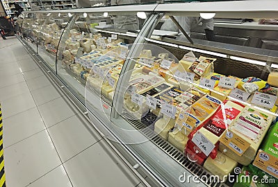 Cheese cheeses on super market front store prices labes on it , glass protective front Editorial Stock Photo