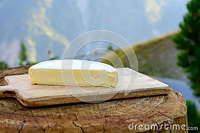 Cheese collection, French reblochon de savoie cheese served outdoor in Savoy region, with Alpine mountains peaks on background Stock Photo