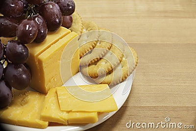 Cheese and Crackers with Grapes on Plate Stock Photo