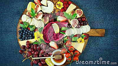 Cheese and fruit charcuterie dessert grazing platter on wooden board. Stock Photo