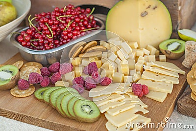 Cheese and fruits on a beautifully vintage decorated table Stock Photo