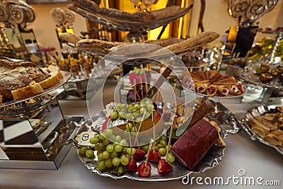 Cheese, fruits, green grapes, nuts, cherries, bread, luxury candy bar Stock Photo