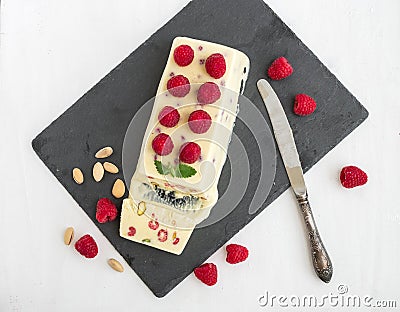 Cheese ice-cream with fresh raspberry and pistachios Stock Photo