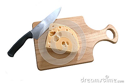 Cheese and knife on bread board Stock Photo