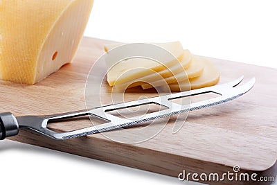 Cheese knife on cutting board Stock Photo