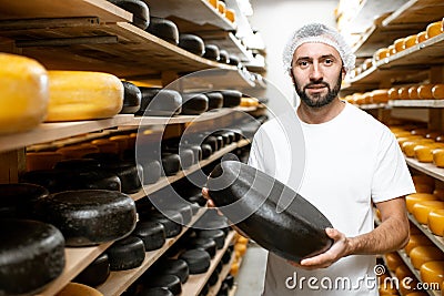 Cheese maker at the cheese storage Stock Photo