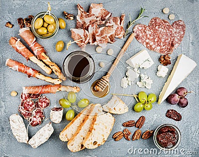 Cheese and meat appetizer selection or wine snack set. Variety of cheese, salami, prosciutto, bread sticks, baguette Stock Photo