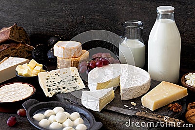 Cheese, milk and dairy products on rustic dark wood and slate ba Stock Photo