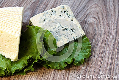 Cheese with a noble mold with lettuce leaves Stock Photo