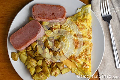 cheese omelet served with home fries and spam Stock Photo