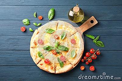 Cheese pizza, tomatoes and olive oil on wooden background Stock Photo