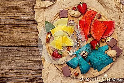 Cheese plate. Assorted multicolored hard Dutch cheeses. Blue and red pesto, aged gouda Stock Photo