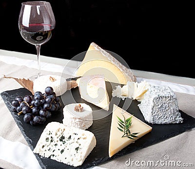 Cheese Plate with Red Wine, vine and Honey on black background Stock Photo