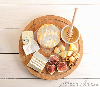 Cheese plate - various types of cheese, honey and figs Stock Photo