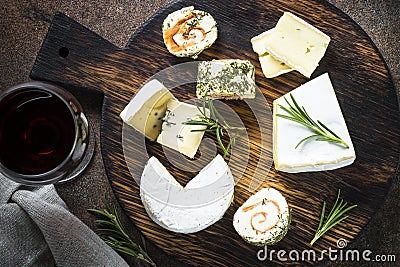 Cheese platter on dark stone table. Stock Photo