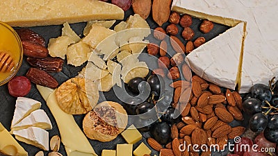 Cheese platter with various types of cheese - parmesan brie roquefort camembert maasdam. Gourmet appetizer, snack food. Assortment Stock Photo