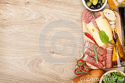 Cheese, prosciutto, bread, vegetables and spices Stock Photo